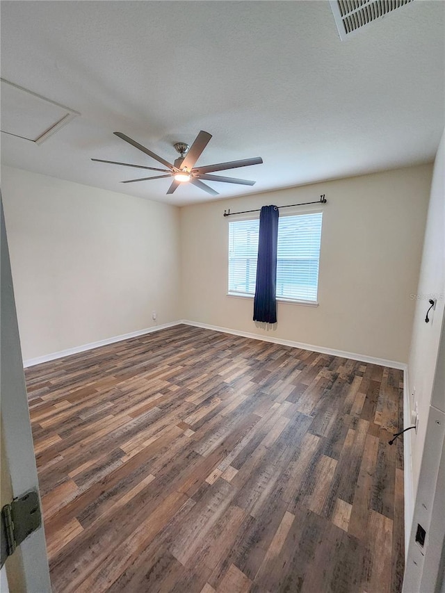 empty room featuring dark wood-type flooring and ceiling fan