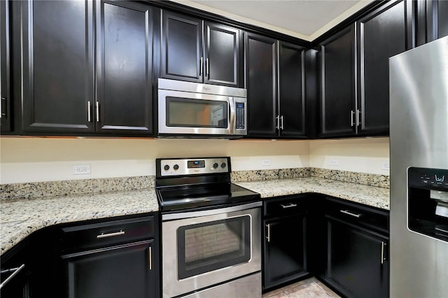 kitchen featuring light stone counters, light tile patterned floors, and appliances with stainless steel finishes