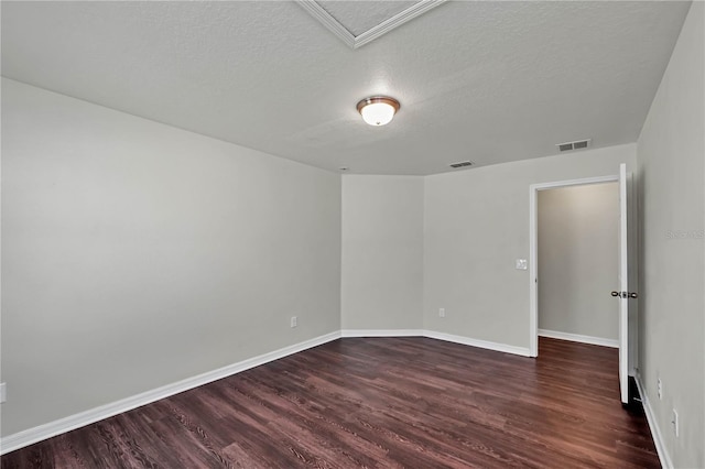 unfurnished room with dark hardwood / wood-style flooring and a textured ceiling