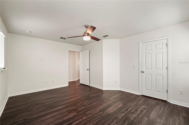 empty room with dark wood-type flooring and ceiling fan