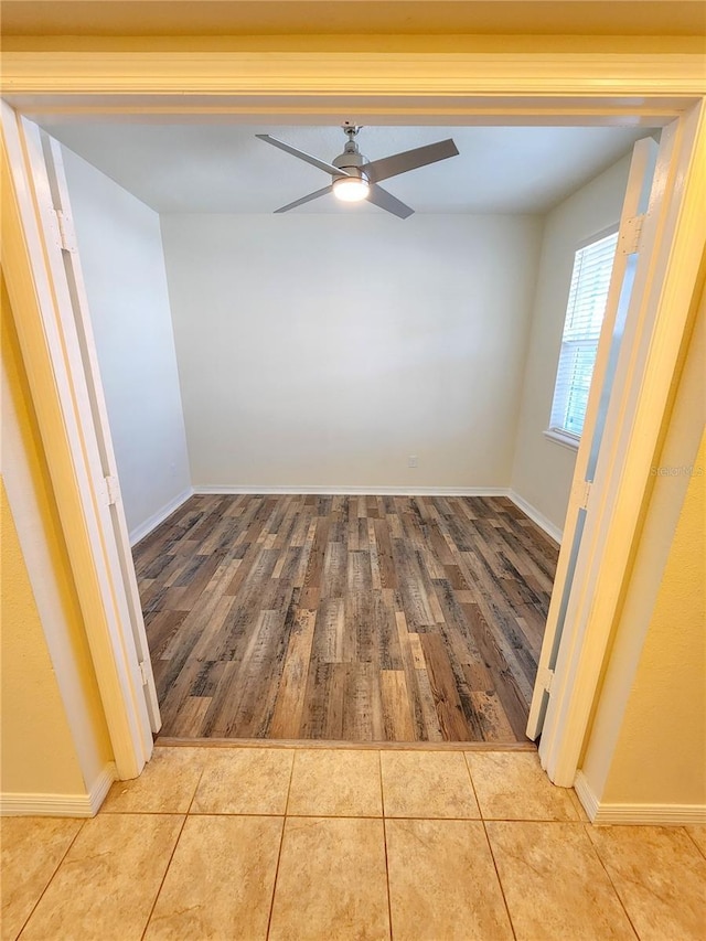 empty room with light tile patterned floors and ceiling fan