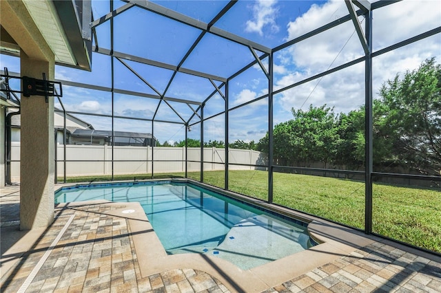 view of swimming pool featuring a lawn, a patio, and glass enclosure