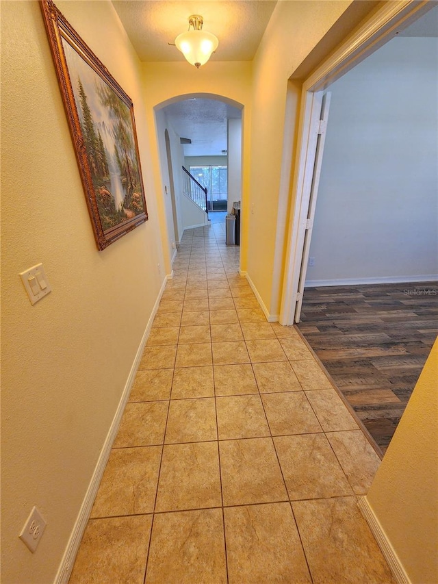 hallway featuring light tile patterned floors