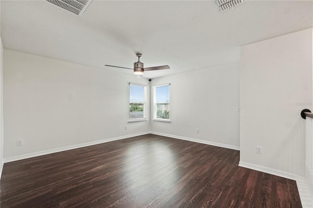 empty room with ceiling fan and dark wood-type flooring