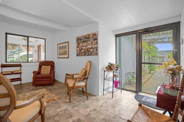 living area featuring ceiling fan and light tile patterned floors