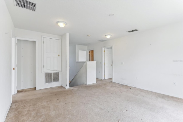 empty room featuring light colored carpet