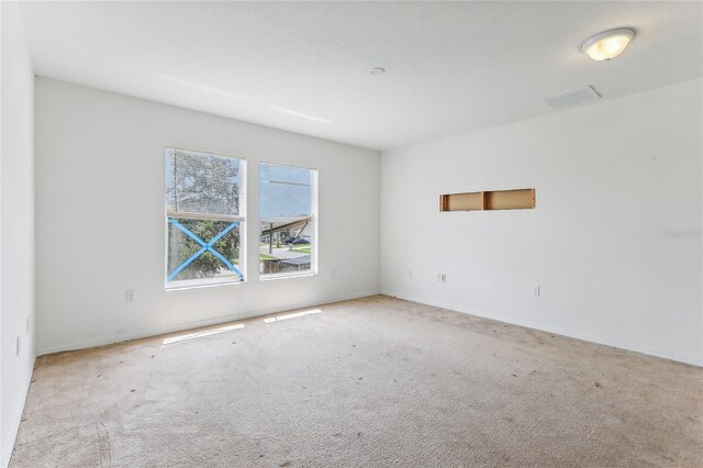 empty room with light colored carpet