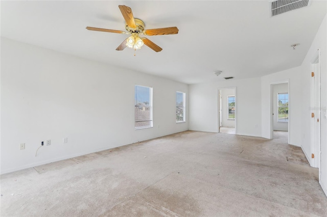 unfurnished living room with ceiling fan and light colored carpet