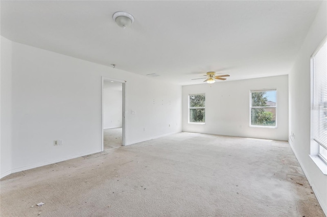 empty room with ceiling fan and light colored carpet