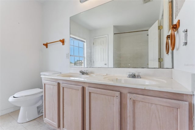 bathroom featuring tile patterned flooring, toilet, and vanity