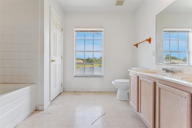 full bathroom with a bathtub, plenty of natural light, vanity, and visible vents