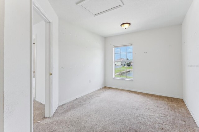 unfurnished room featuring light carpet