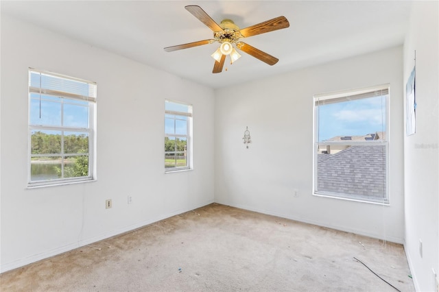 carpeted empty room with ceiling fan