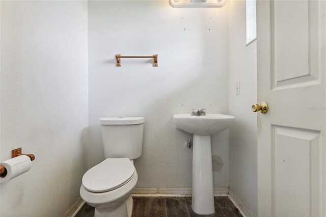 bathroom featuring hardwood / wood-style flooring and toilet