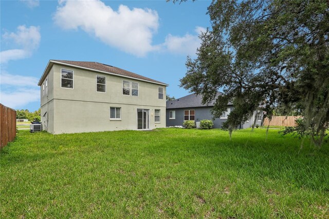 back of house featuring a yard