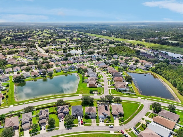 bird's eye view featuring a water view and a residential view