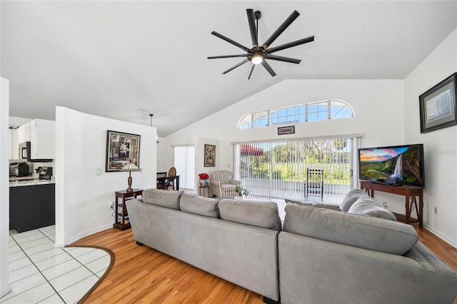 living room with light hardwood / wood-style flooring, ceiling fan, and lofted ceiling