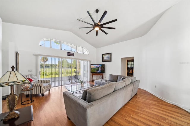 living room with ceiling fan, high vaulted ceiling, and light hardwood / wood-style floors