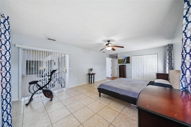 tiled bedroom featuring a closet and ceiling fan