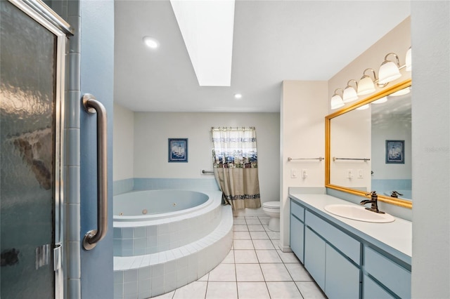 full bathroom with vanity, a skylight, tile patterned flooring, independent shower and bath, and toilet