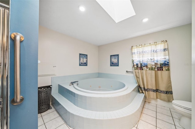 bathroom featuring tiled bath, toilet, a skylight, and tile patterned floors