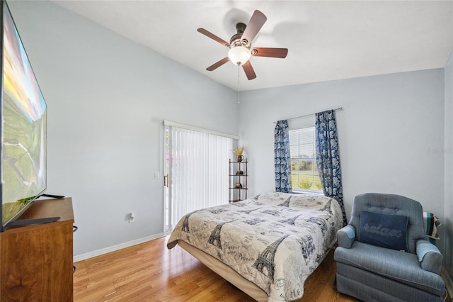 bedroom with hardwood / wood-style flooring, lofted ceiling, and ceiling fan