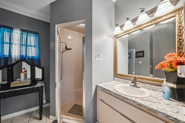 bathroom featuring tile patterned floors, an enclosed shower, and vanity