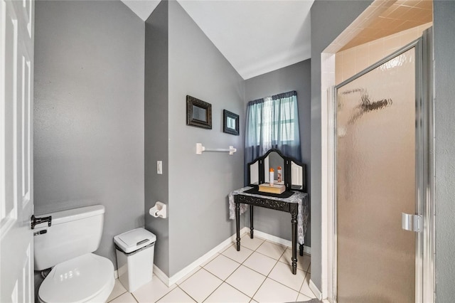 bathroom featuring a shower with shower door, toilet, and tile patterned floors