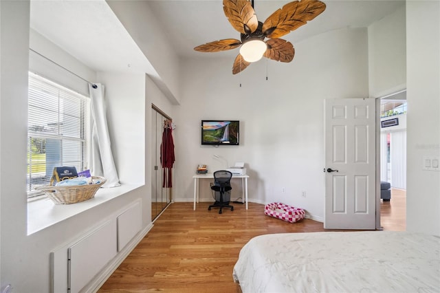 bedroom with ceiling fan and light hardwood / wood-style floors