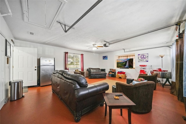 living room with ceiling fan and a textured ceiling