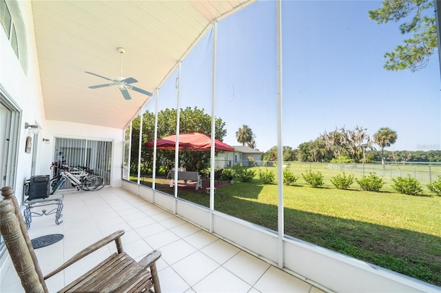 unfurnished sunroom with ceiling fan and lofted ceiling