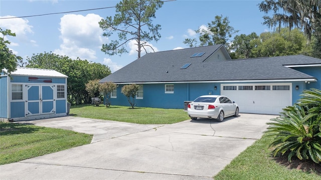 view of front of property featuring a front yard and a garage