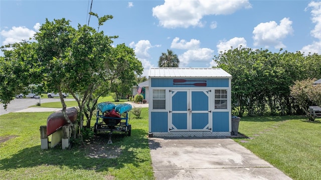 view of outbuilding featuring a yard