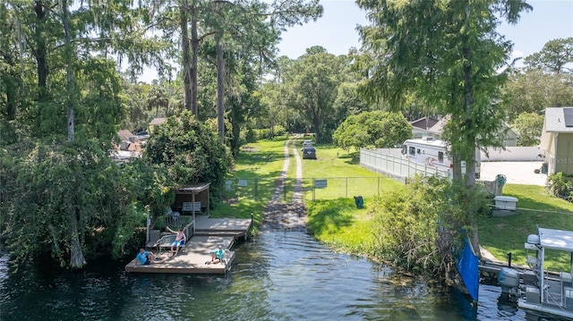 dock area with a water view and a yard