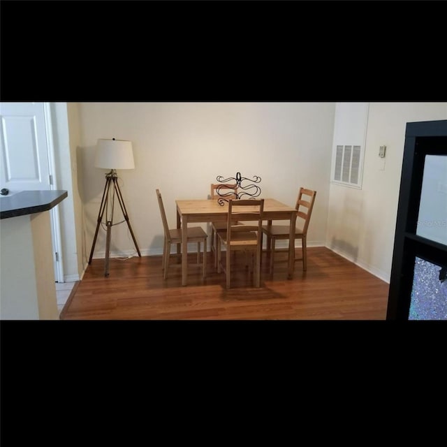 dining room with hardwood / wood-style floors