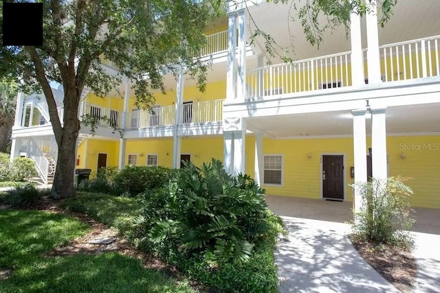 exterior space with a balcony and central AC unit