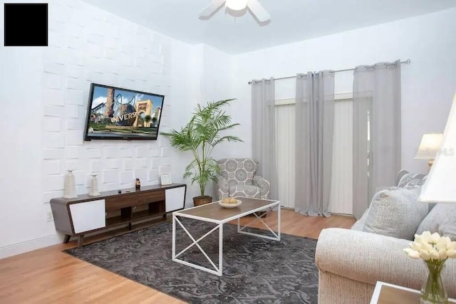 living room with wood-type flooring and ceiling fan