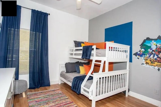 bedroom with ceiling fan and hardwood / wood-style flooring