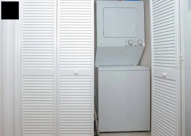 washroom with stacked washer and clothes dryer