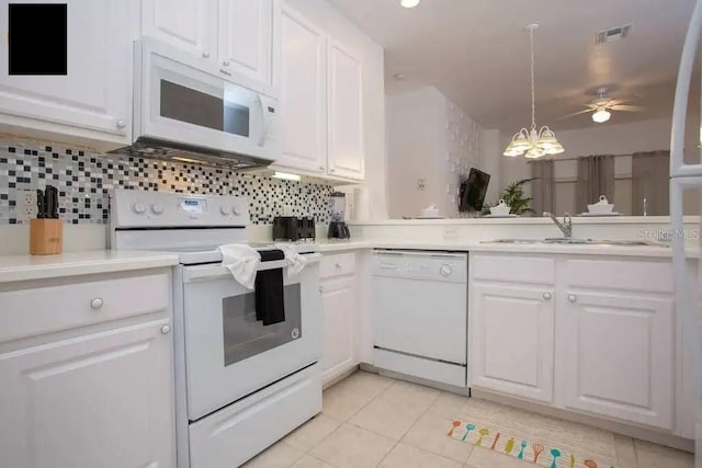 kitchen featuring white cabinets, white appliances, light tile patterned floors, and sink