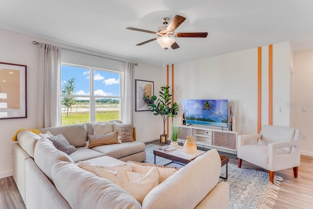 living room featuring light wood-type flooring and ceiling fan