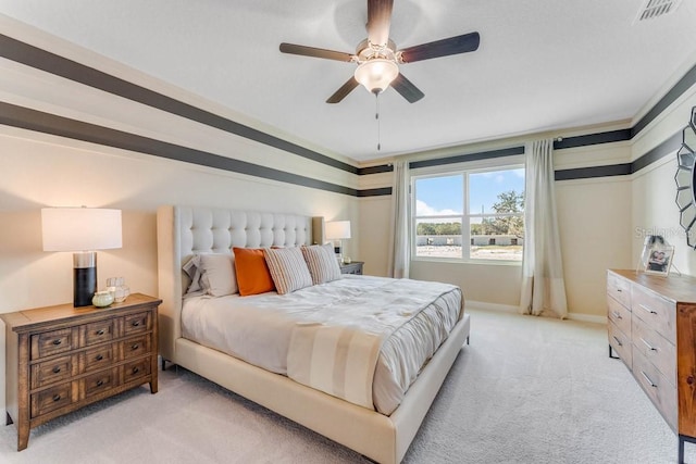 bedroom featuring ceiling fan, ornamental molding, and light carpet