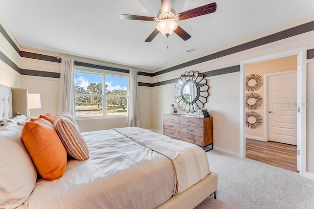 carpeted bedroom with ceiling fan and crown molding