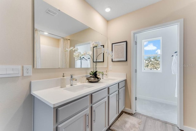 bathroom with vanity and hardwood / wood-style flooring