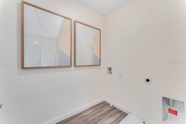 laundry area with hookup for an electric dryer, hookup for a washing machine, and hardwood / wood-style flooring