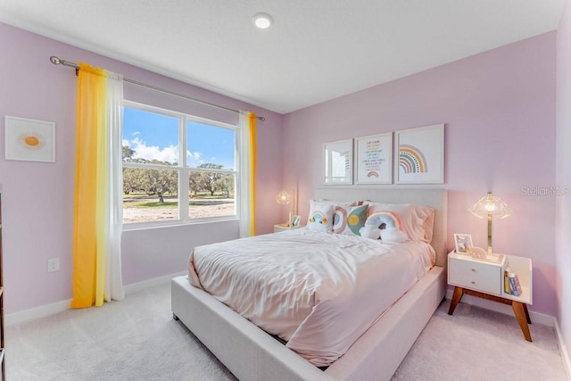 bedroom featuring light colored carpet