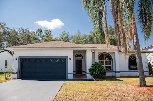 ranch-style house featuring a garage and a front lawn