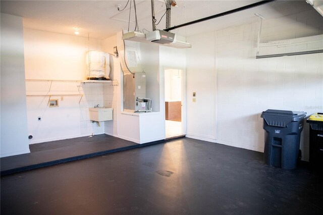 garage featuring a sink and a garage door opener