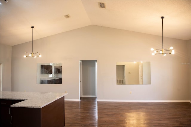 interior space with dark hardwood / wood-style flooring, high vaulted ceiling, decorative light fixtures, and a chandelier