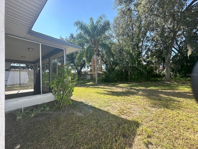 view of yard with a sunroom